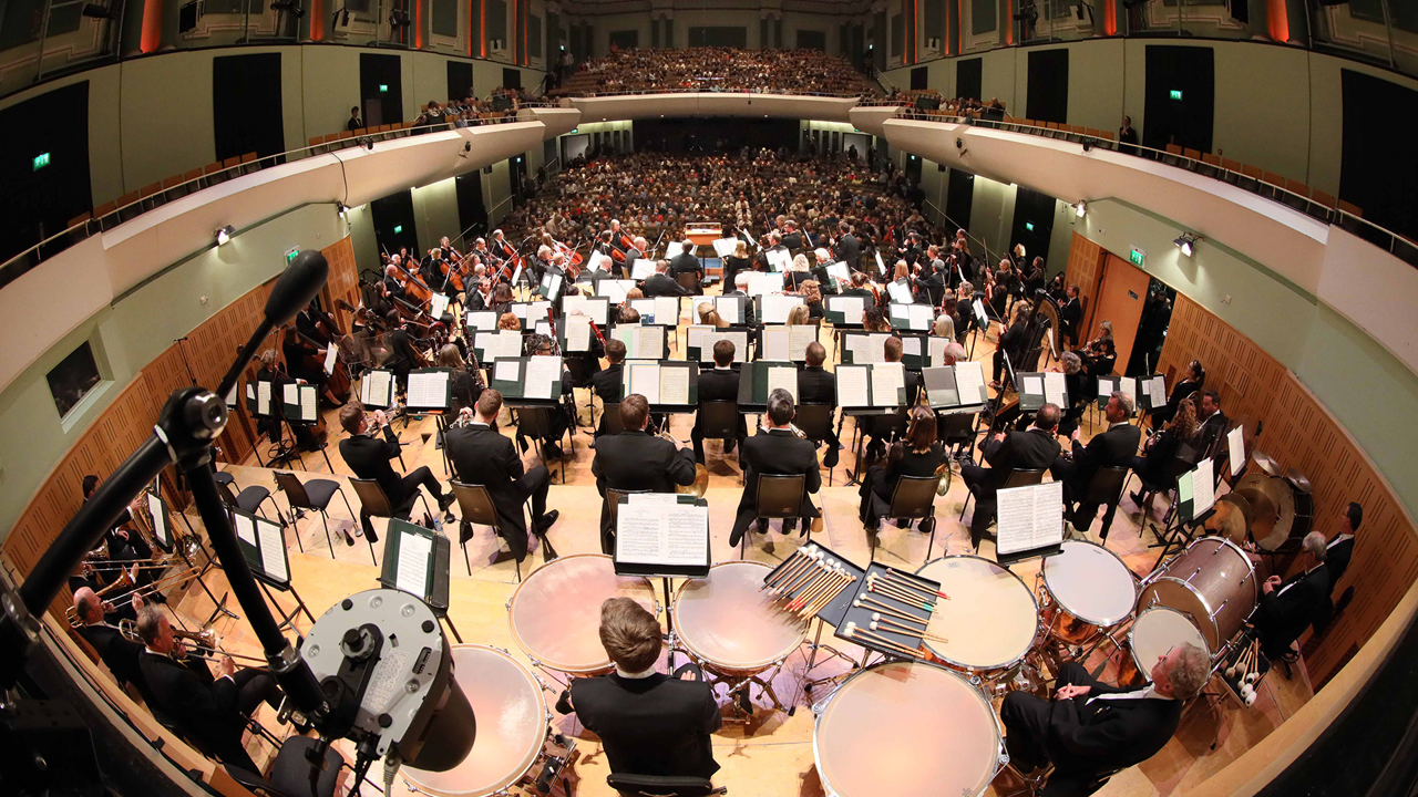 Fish-eye lens image of the National Symphony Orchestra taken from behind the orchestra