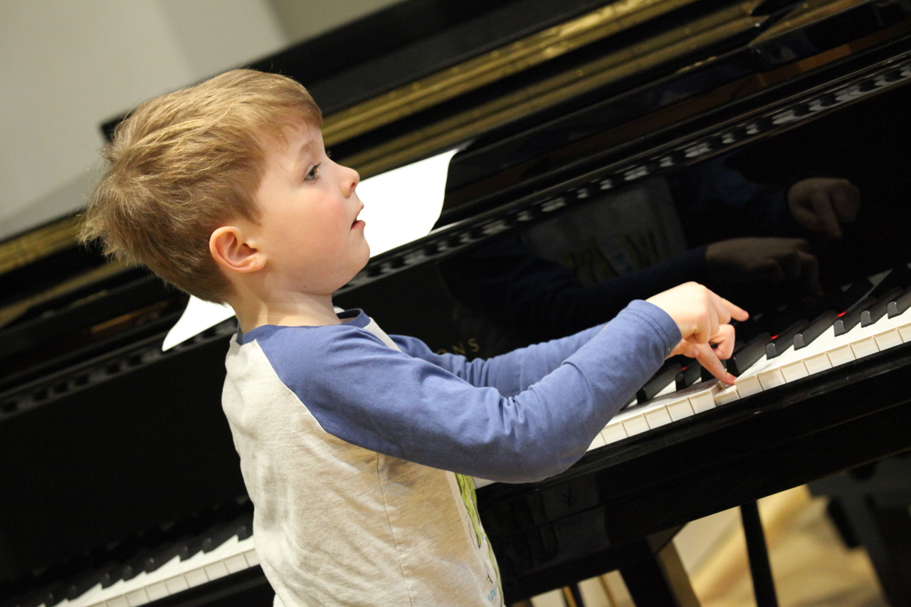 Young boy plays piano during the Totally Made-up Orchestra in New Music Dublin