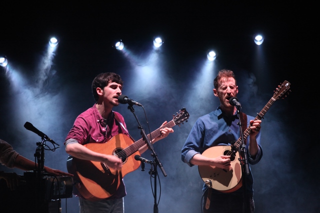 Ye Vagabonds - two men with guitar and mandolin against a dark backdrop on NCH Stage