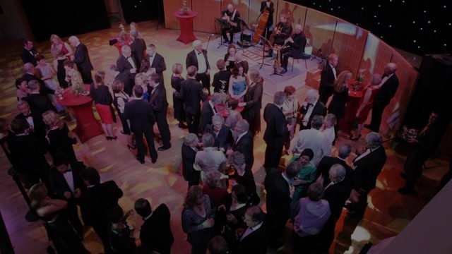 Aerial shot of men and women on the NCH stage at an event